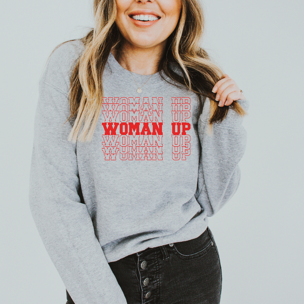 a woman wearing a sweatshirt that says woman up