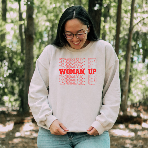 a woman wearing a sweatshirt that says woman up