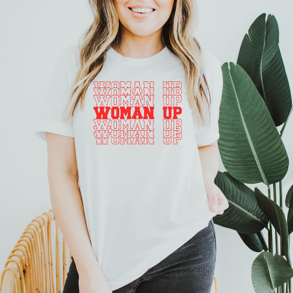 a woman wearing a t - shirt that says woman up