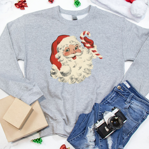 Gray sweatshirt with Santa Claus graphic on a white background with Christmas decor.