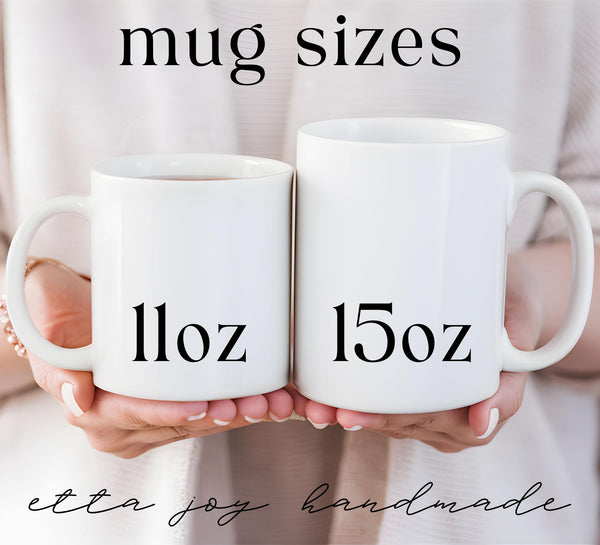 two white coffee mugs with numbers on them