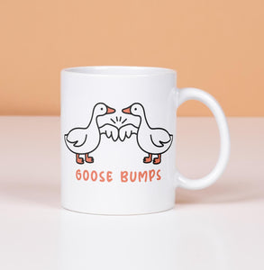 Goose Bumps mug.  2 geese first bumping