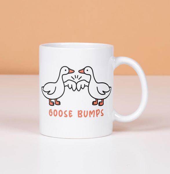 Goose Bumps mug.  2 geese first bumping
