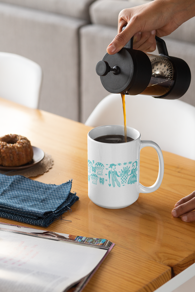 Person pouring coffee from a French press into a white mug with blue designs on a wooden table.